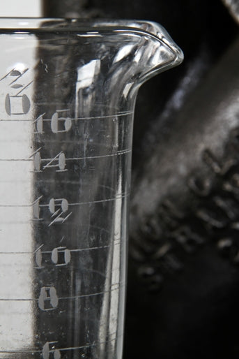 very clean and well maintained all original early 20th century american laboratory pressed glass conical-shaped measure with etched markings