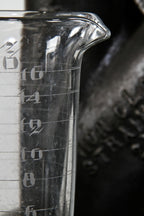 very clean and well maintained all original early 20th century american laboratory pressed glass conical-shaped measure with etched markings