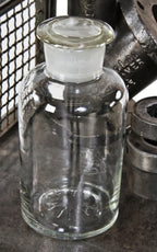 all original and seldom found oversized early 20th century antique american industrial well-maintained and cleaned clear glass "thorium" laboratory bottle with original ground glass stopper
