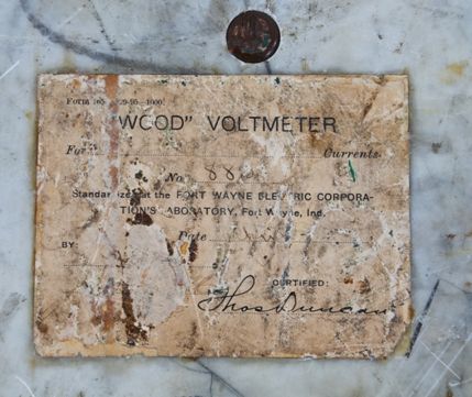 late 19th century ornamental cast bronze "wood type" flush mount switchboard volmeter with original certification label signed by thomas duncan