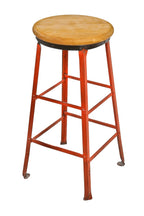 early 1940's original burnt orange enameled riveted joint angled steel factory machine shop four-legged stool with multiple stretchers and a solid maple wood seat