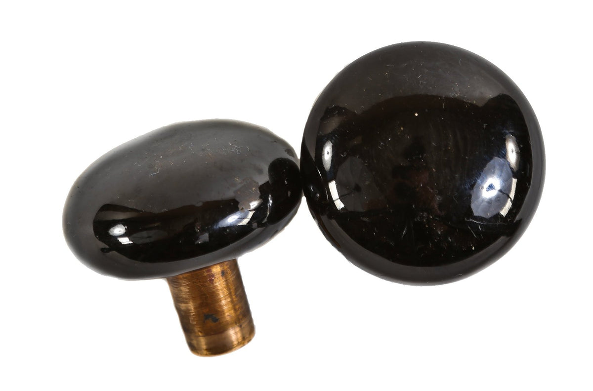 original and lightly cleaned late 19th century antique american interior residential "jet black" porcelain passage size doorknobs with desirable cast brass shanks