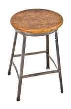 original 1930's american antique industrial four-legged riveted joint angled steel factory machine shop stool with weathered and worn solid maple wood seat