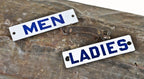 matching set of c. 1950's original single-sided american industrial factory lavatory door "men" & "ladies" porcelain enameled die cut steel signs with cobalt blue lettering