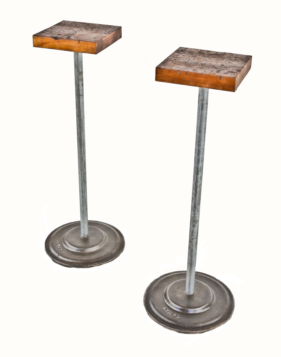 two matching repurposed american industrial freestanding tubular steel display stands with weighted cast iron bases and rock hard maple wood square tops