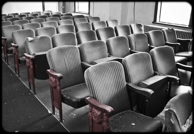 refinished original c. 1920's freestanding heavily ornamented cast iron theater seat end with solid birch wood set rest and opposed female faces with flowing hair