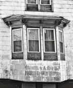 single diminutive early 1860's original antique american italianate style painted pine wood exterior residential bay window denailed bracket or corbel