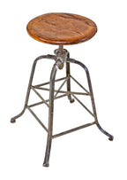original highly desirable early 1920's adjustable height four-legged riveted-joint steel stationary factory machinist stool with original solid oak wood revolving seat