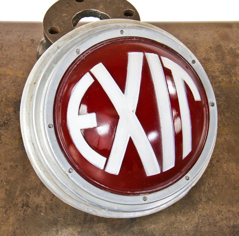 all original and completely functional machine age art deco style interior wall-mount illuminated exit light fixture with intact ruby red glass convex-shaped lens