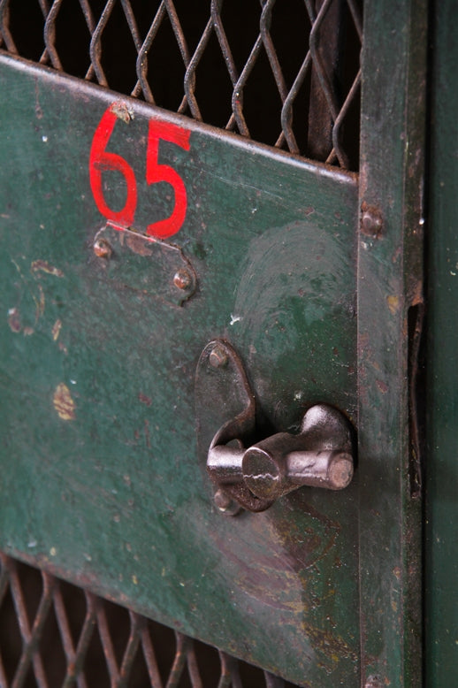 rare and highly sought after early 20th century largely intact "expanded metal type" green painted federal freestanding locker unit with hand-painted red numbers