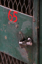 rare and highly sought after early 20th century largely intact "expanded metal type" green painted federal freestanding locker unit with hand-painted red numbers