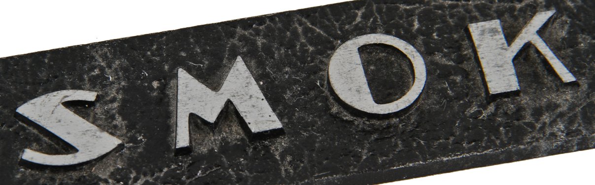 one of two original c. 1930's american art deco style single-sided reinforced cast aluminum surface mount cast aluminum "no smoking" informational sign with black enameled finish