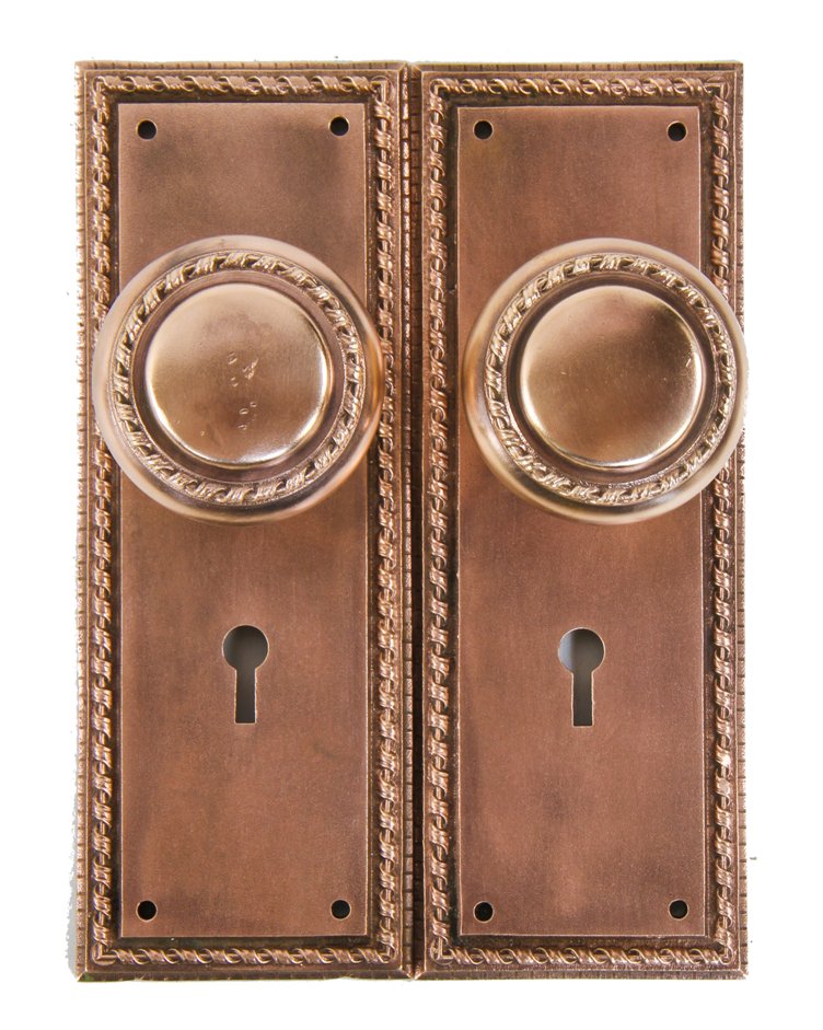 late 19th or possibly early 20th century antique american mostly uniform ornamental cast bronze interior residential matching doorknobs complete with backplates
