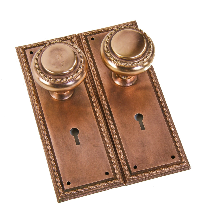 one of many matching original early 20th century finely crafted heavy cast bronze interior residential doorknobs and matching backplates