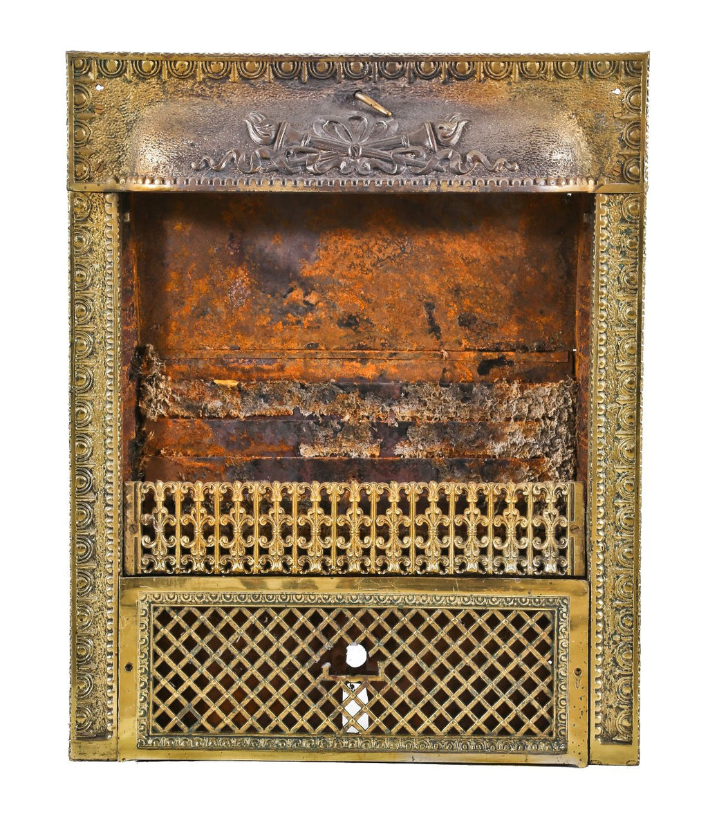 late 19th or early 20th century antique american ornamental stamped or pressed steel interior residential fireplace gas grate with overlapping fluted torches