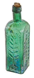 original early 1860's skillfully crafted emerald green hand-blown "pine tree tar cordial" dug bottle with pontil scar and slanted neck containing vertical straw marks ans seeds