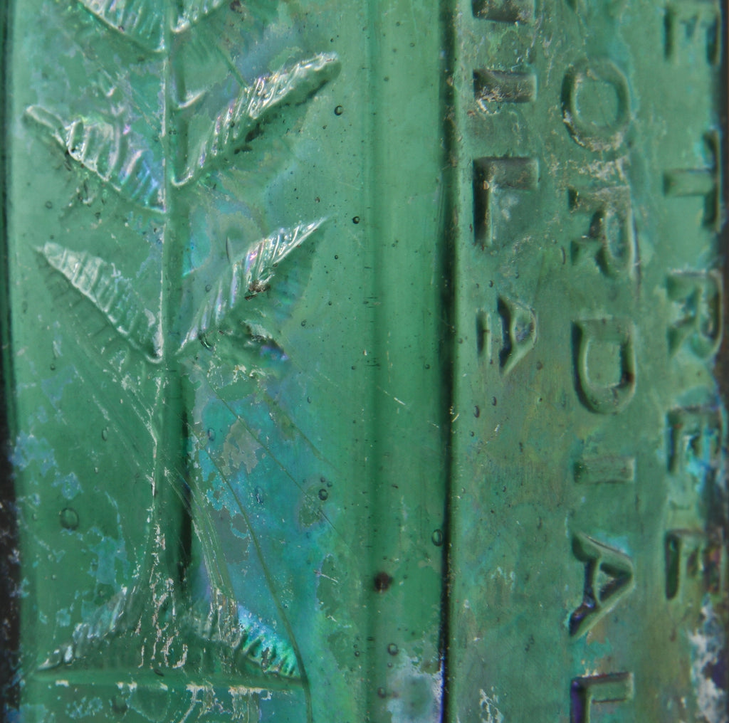 original early 1860's skillfully crafted emerald green hand-blown "pine tree tar cordial" dug bottle with pontil scar and slanted neck containing vertical straw marks ans seeds