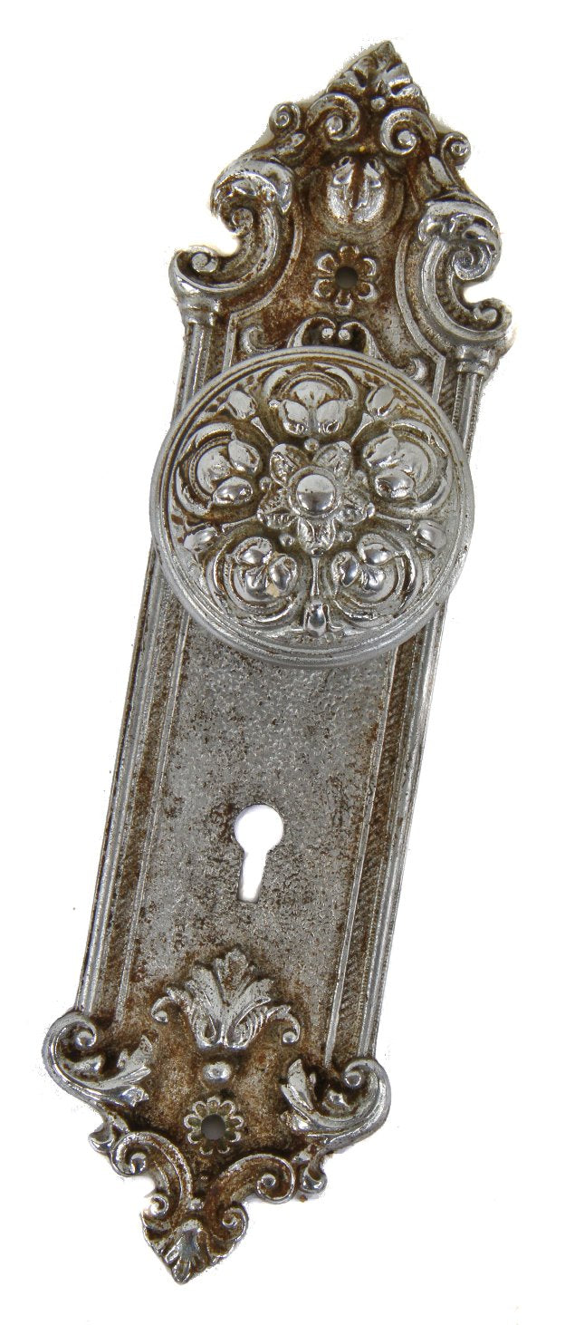 chrome plated early 20th century matching antique american interior residential cast iron doorknob and backplate or escutcheon with single keyhole