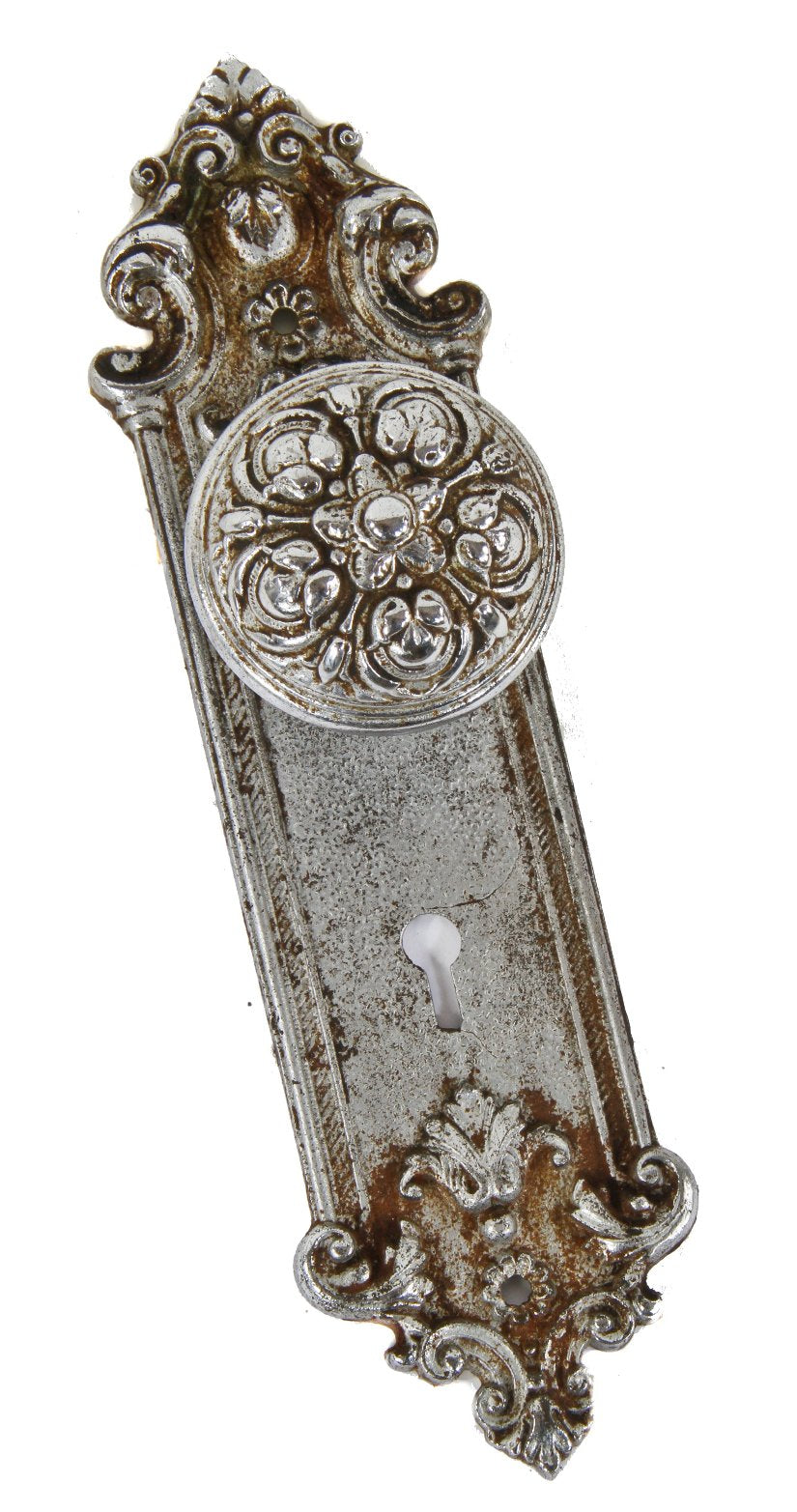 matching early 20th century ornamental chrome plated cast iron "pasco" pattern interior residential doorknob and matching backplate or escutcheon