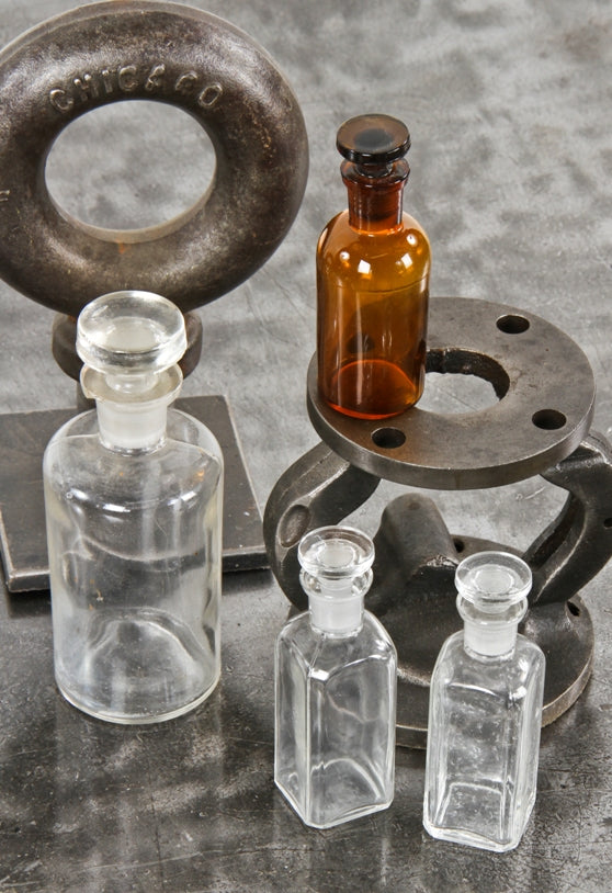 group of four turn of the century amber and clear glass american medical research laboratory "new old stock" reagent bottles with original ground glass stoppers