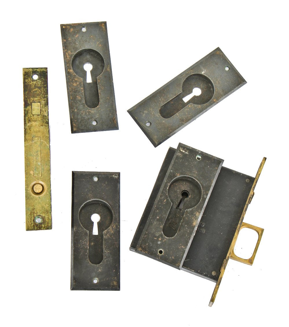 all original and completely intact late 1880's unornamented cast iron interior residential sliding or pocket door hardware with fully functional mortise locks
