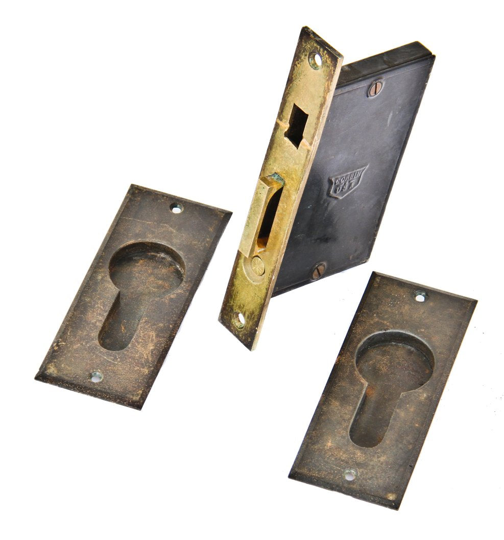 original late 19th century single sliding interior residential pocket door unornamented cast iron escutcheons with matching fully functional mortise lock