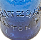 mid-nineteenth century (1853-1865) sapphire blue pontiled porter bottle finished with a tapered collar and ring manufactured by a philadelphia area glassworks.