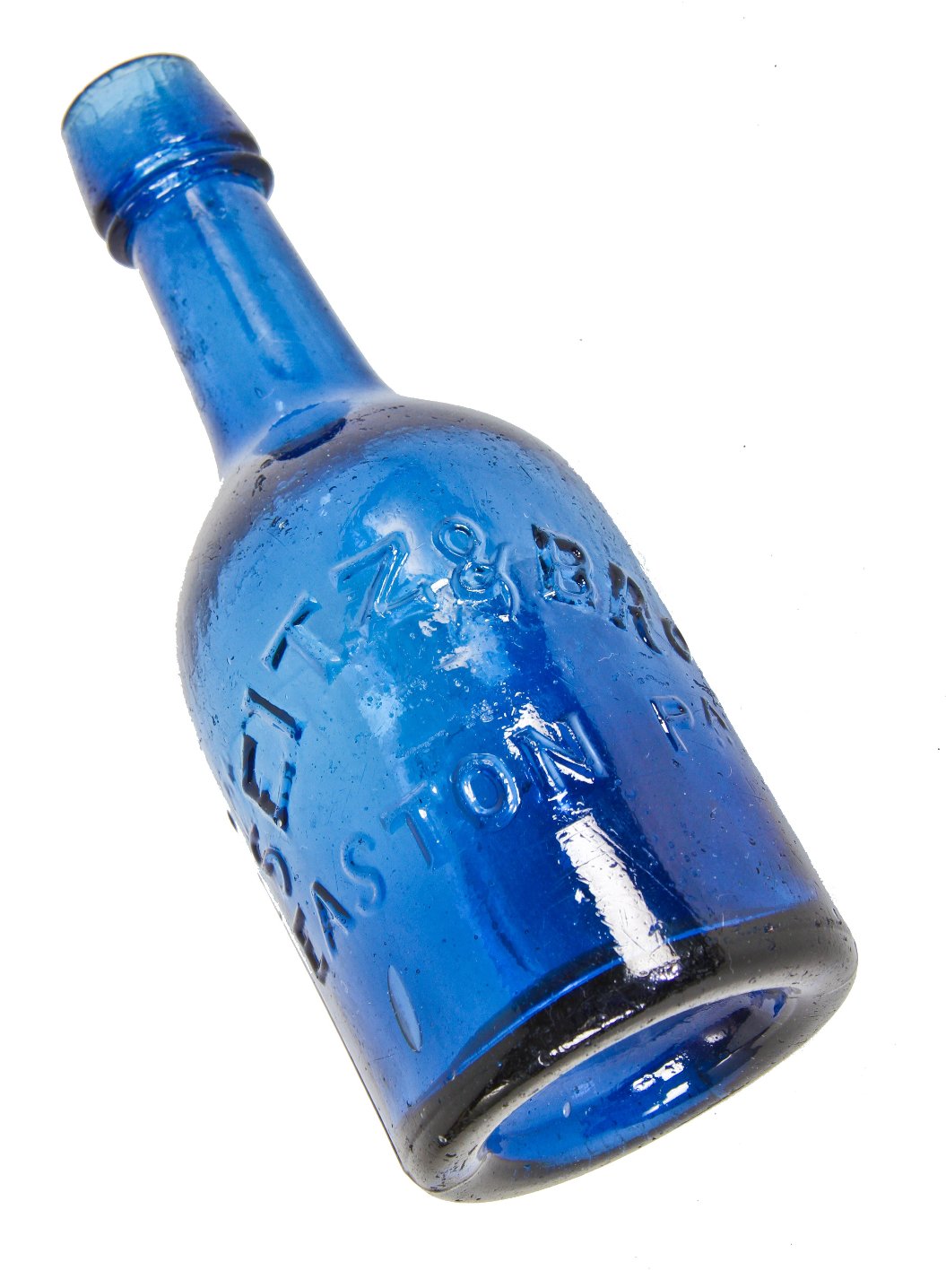 mid-nineteenth century (1853-1865) sapphire blue pontiled porter bottle finished with a tapered collar and ring manufactured by a philadelphia area glassworks.