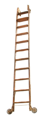 one of two original early 20th century chicago hardware store rolling "library" style varnished oak wood ladder with intact hangers and track