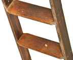 one of two original early 20th century chicago hardware store rolling "library" style varnished oak wood ladder with intact hangers and track