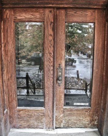 pair of original c. 1897 exterior chicago two-flat residential two-part or double door assembly comprised of varnished oak wood with beveled edge plate glass panes