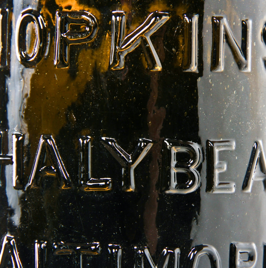 rare  mid-nineteenth century yellow olive pint shaped "chalybeate" mineral water bottle manufactured for william hopkins in baltimore, md.