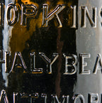 rare  mid-nineteenth century yellow olive pint shaped "chalybeate" mineral water bottle manufactured for william hopkins in baltimore, md.