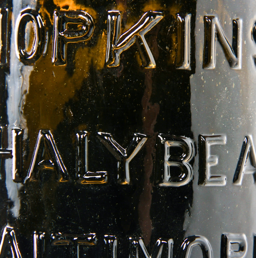 rare  mid-nineteenth century yellow olive pint shaped "chalybeate" mineral water bottle manufactured for william hopkins in baltimore, md.