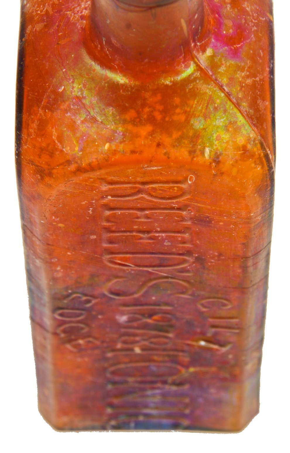 heavily iridized 19th century privy dug antique american square amber bitters bottle with tapered collar manufactured for geo w.m. reed in connecticut.