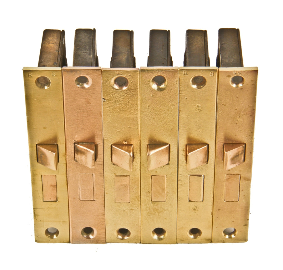 group of six matching fully functional c. 1897 interior residential passage door mortise locks with refinished unornamented cast brass faceplates
