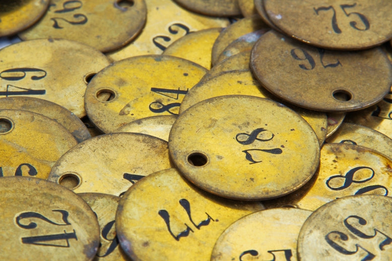 large lot of early 20th century historic la salle hotel stamped brass numbered coat check circular-shaped tags with incised numbers