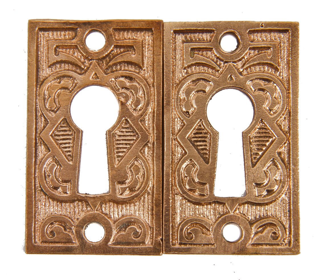nicely aged original 19th century interior residential eastlake style ornamental cast brass pass door keyhole escutcheons with mostly uniform surface patina