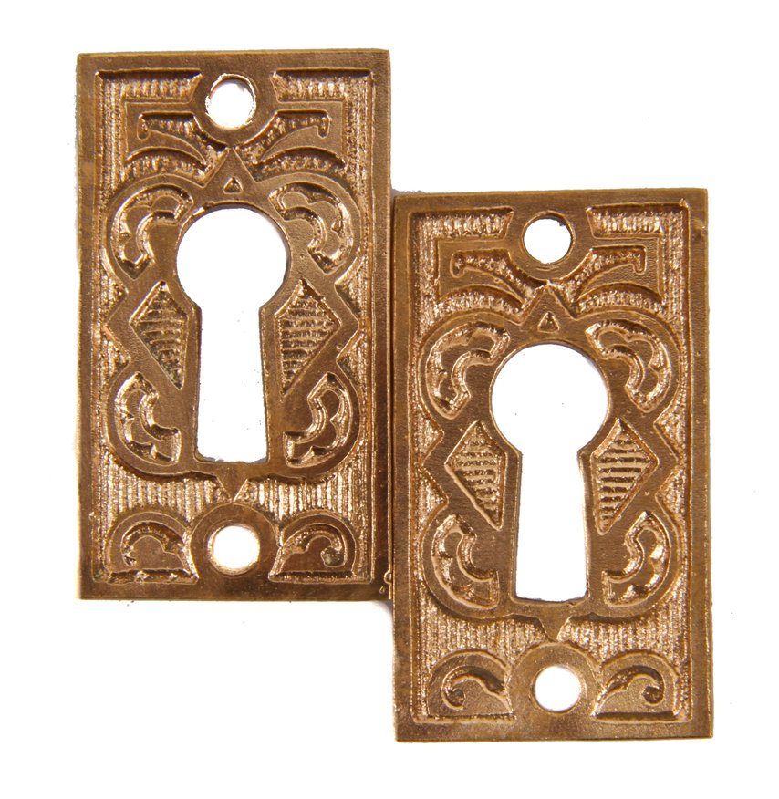 two matching original 19th century cast brass interior residential ornamental cast brass keyhole escutcheons with a uniform surface patina