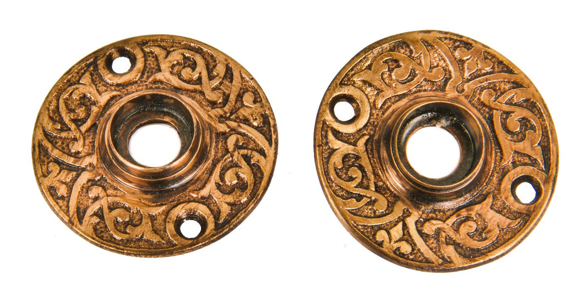 matching set or pair of original late 19th century antique american ornamental cast brass interior residential doorknob rosettes with stepped thimbles