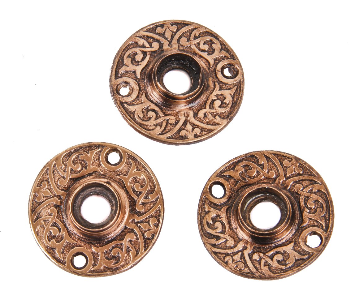 three matching original 19th century highly ornamented cast brass interior residential doorknob rosettes with allover foliated scrollwork surrounding the thimbles