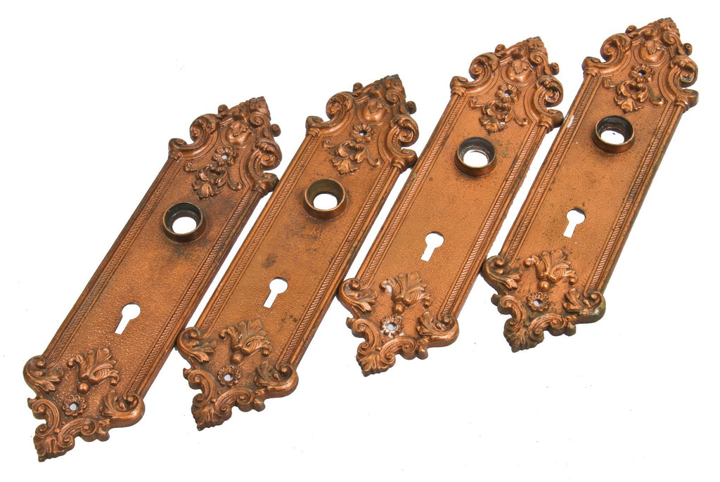 four matching late 19th century antique american copper-plated cast iron interior residential "pasco" pattern doorknob backplates salvaged from a chicago two-flat