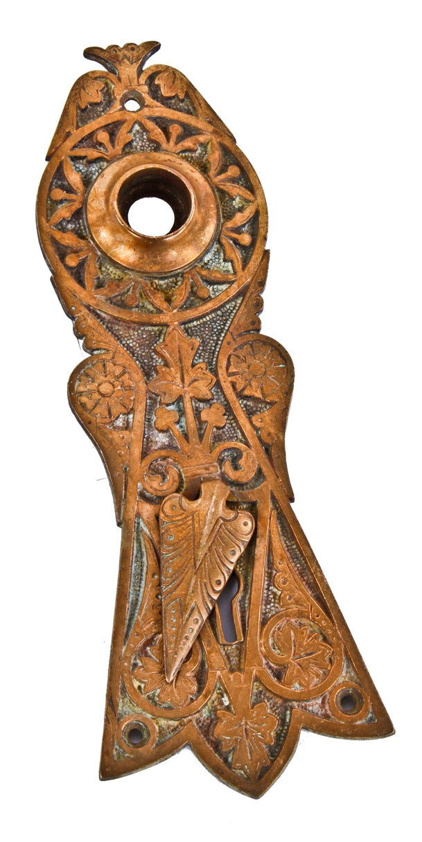 original hard to find and highly desirable oversized metallic compression c. 1870's entrance door backplate with intact swinging arrowhead design keyhole cover