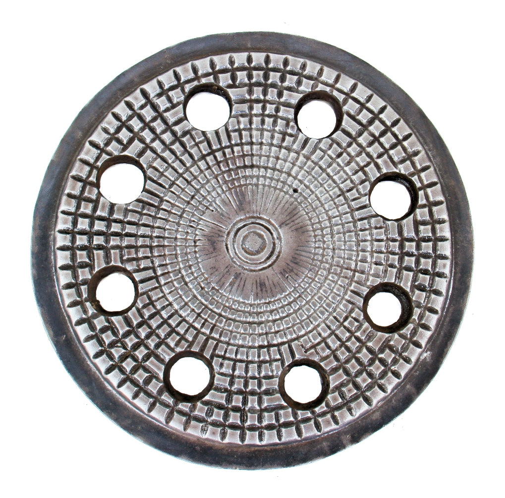 original 19th century city of chicago commercial building ornamented cast iron sidewalk coal chute circular-shaped cover with a multitude of holes once containing glass vault lenses