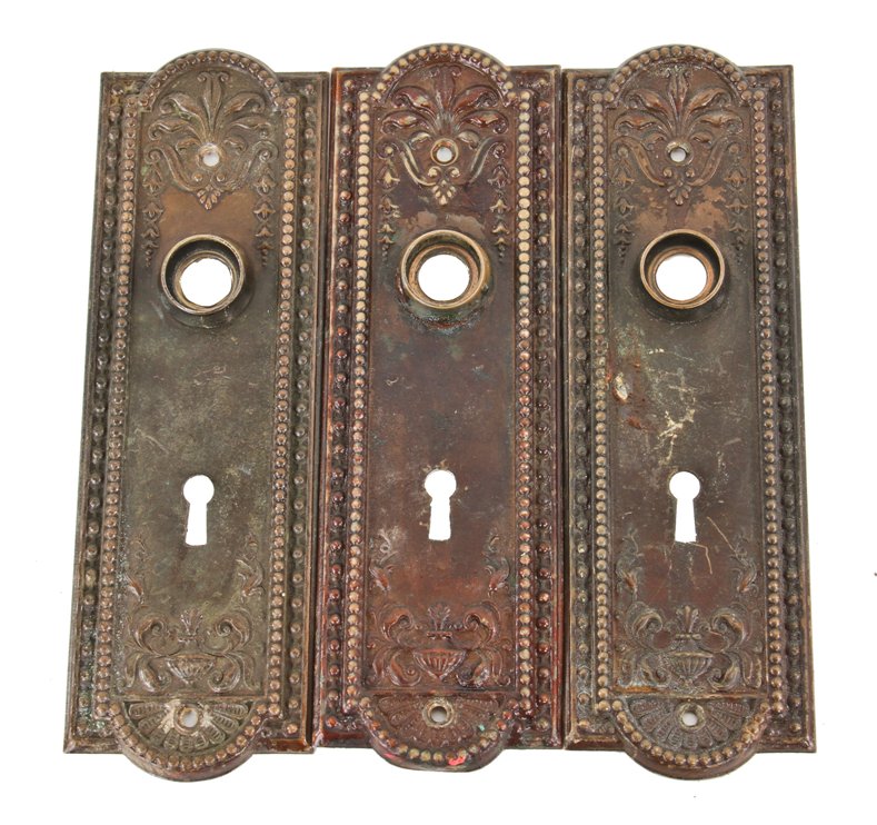 matching lot of original turn of the century ornamental wrought brass "como" pattern residential interior passage door backplates or escutcheons