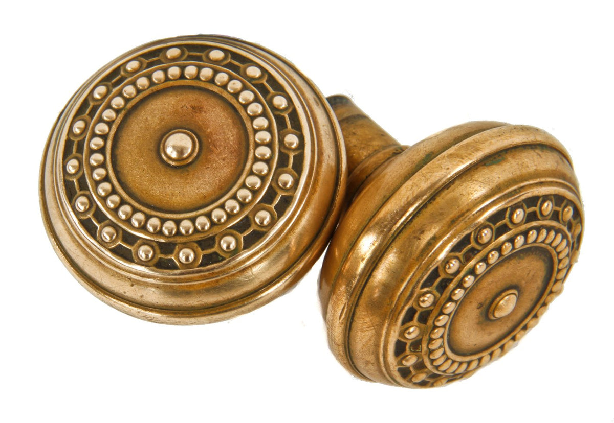 polished early 1900's antique american ornamental wrought brass interior residential "como" pattern banded rim doorknobs