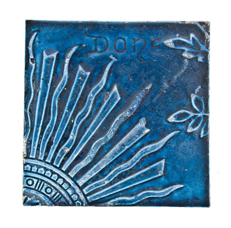 original 19th century dark blue majolica glazed antique american eastlake style "sunburst" pattern residential fireplace hearth ceramic tile with the word "done"