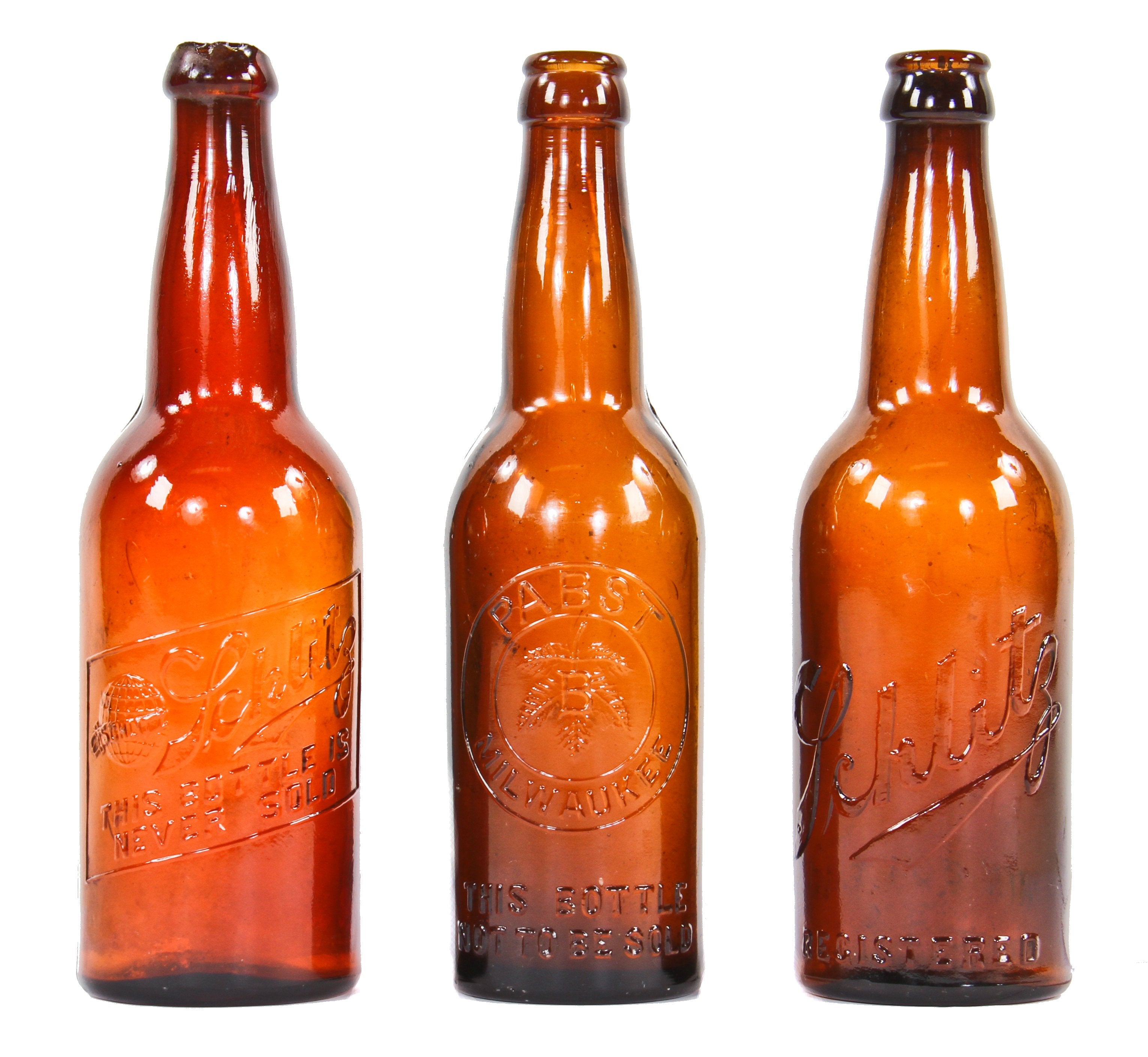 three early twentieth century pre-prohibition era embossed amber glass beer bottle manufactured for the pabst and schlitz brewing companies.