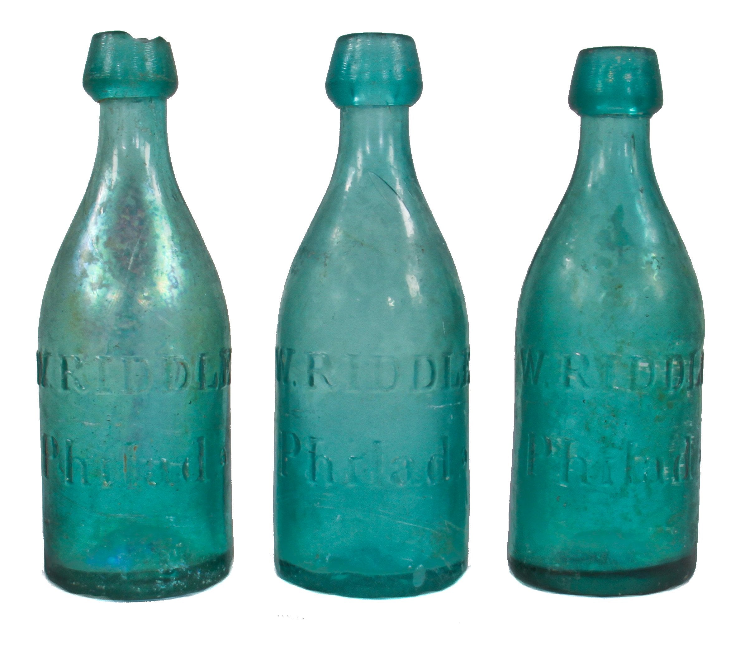 three matching privy dug mid-nineteenth century vibrant blue green glass iron pontiled soda bottles manufactured for william riddle in philadelphia, pa.