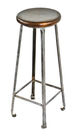 single depression era american made antique industrial four-legged refinished brushed angled metal tall factory machine shop stool with darkly stained wood seat